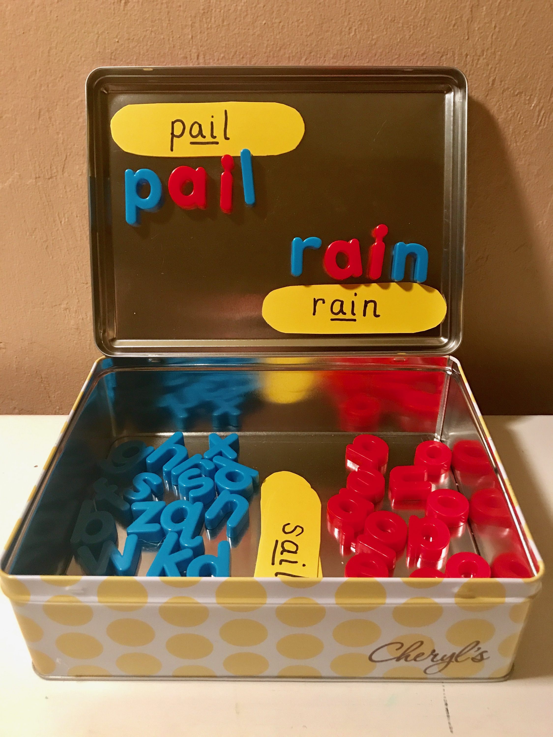 Phonics metal box and magnetic letters to create phonogram 'ai' words 